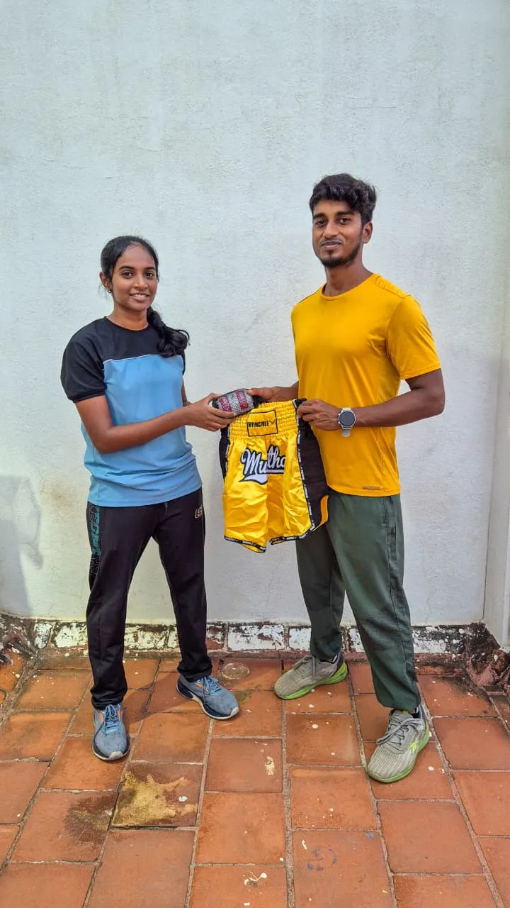 Harinee receives Muay Thai shorts and hand wraps after her 3rd-round knockout Gold medal win